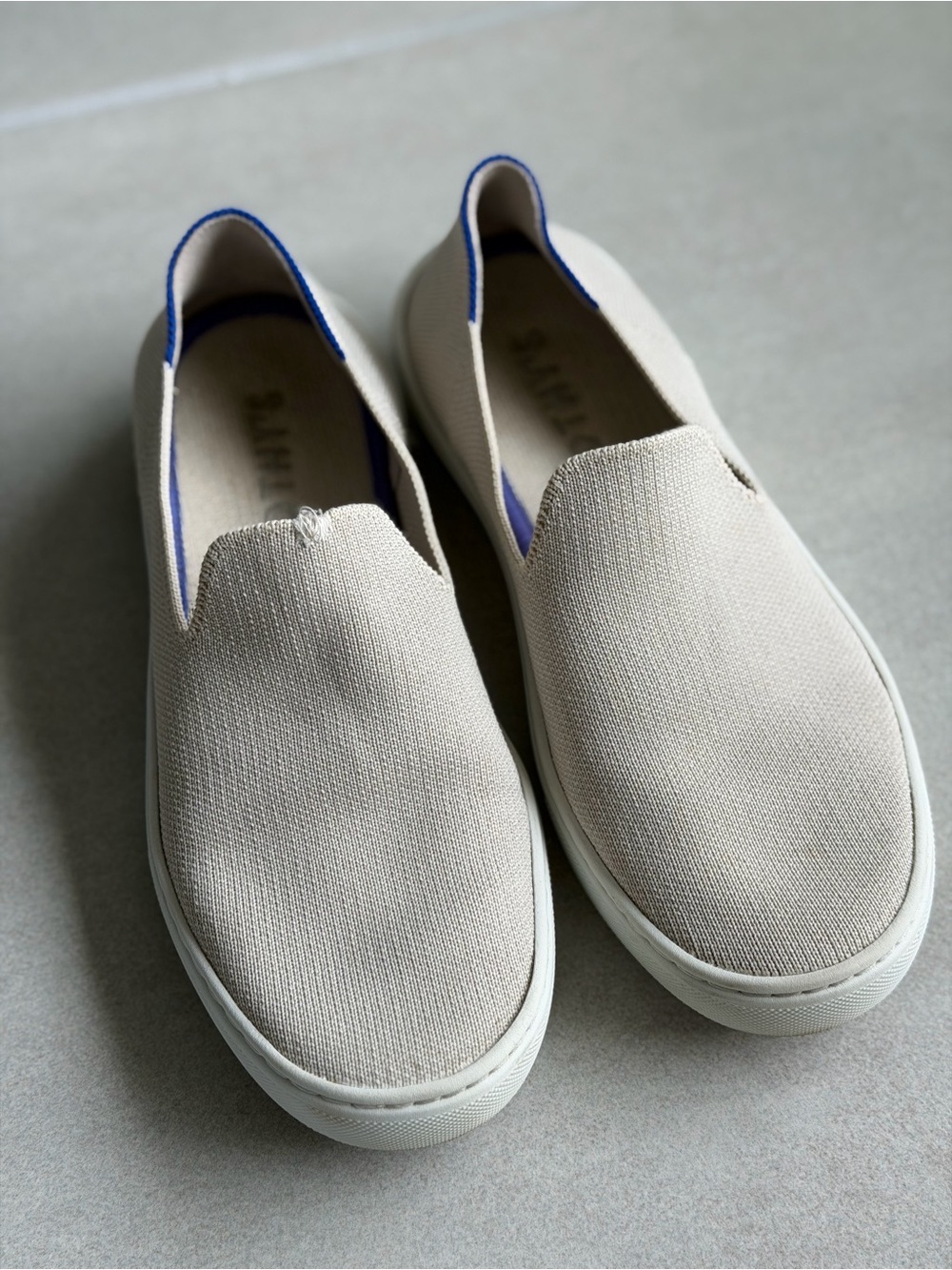 Rothy’s Original Slip-On Canvas Sneakers in Cream with Blue Trim - Picture 2 of 3